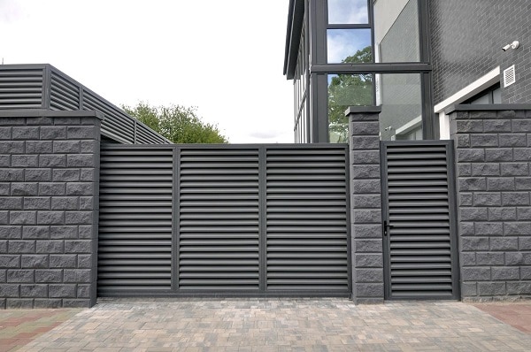 47874284 modern entrance gate and gate to the territory of a private residential building